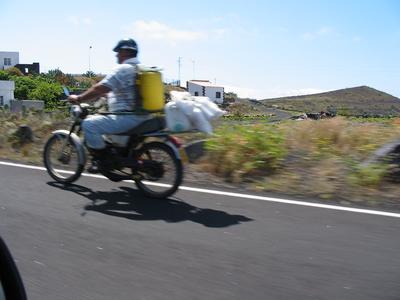 Motorcyclist with white bags
