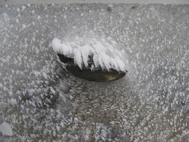 Ice swirls around brick